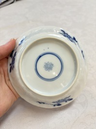 A set of four Chinese blue and white cups and saucers, flower mark, 19th C.