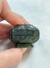 A small Chinese spinach-green jade covered box and two white jade pendants, 18/19th C.