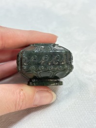 A small Chinese spinach-green jade covered box and two white jade pendants, 18/19th C.