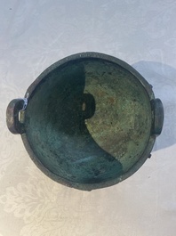 A Chinese archaic bronze tripod food vessel with 'taotie' design, 'ding 鼎', Western Zhou