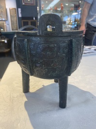 A Chinese archaic bronze tripod food vessel with 'taotie' design, 'ding 鼎', Western Zhou