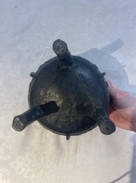 A Chinese archaic bronze tripod food vessel with 'taotie' design, 'ding 鼎', Western Zhou