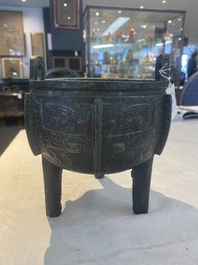 A Chinese archaic bronze tripod food vessel with 'taotie' design, 'ding 鼎', Western Zhou