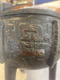 A Chinese archaic bronze tripod food vessel with 'taotie' design, 'ding 鼎', Western Zhou