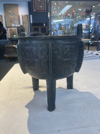 A Chinese archaic bronze tripod food vessel with 'taotie' design, 'ding 鼎', Western Zhou