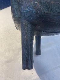 A Chinese archaic bronze tripod food vessel with 'taotie' design, 'ding 鼎', Western Zhou