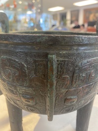 A Chinese archaic bronze tripod food vessel with 'taotie' design, 'ding 鼎', Western Zhou