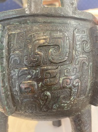 A Chinese archaic bronze tripod food vessel with 'taotie' design, 'ding 鼎', Western Zhou
