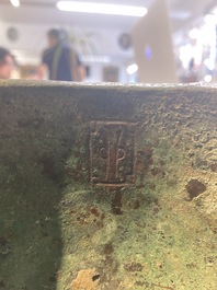 A Chinese archaic bronze tripod food vessel with 'taotie' design, 'ding 鼎', Western Zhou