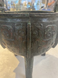 A Chinese archaic bronze tripod food vessel with 'taotie' design, 'ding 鼎', Western Zhou
