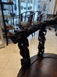 A pair of Chinese finely carved hongmu swivel chairs, Canton, 19th C.