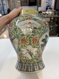 A pair of Chinese famille verte yellow-ground 'Xi Xiang Ji' vases and covers, 19th C.