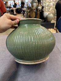 A Chinese Longquan celadon 'lotus' bowl and a large green-glazed Shiwan jar, Ming and later
