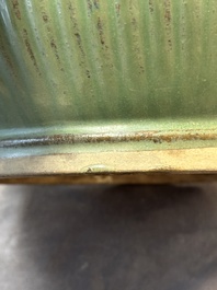 A Chinese Longquan celadon 'lotus' bowl and a large green-glazed Shiwan jar, Ming and later