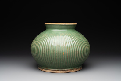 A Chinese Longquan celadon 'lotus' bowl and a large green-glazed Shiwan jar, Ming and later