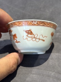 A pair of Chinese polychrome-decorated cups and saucers and an iron-red gilt-decorated cup and saucer, Yongzheng/Qianlong