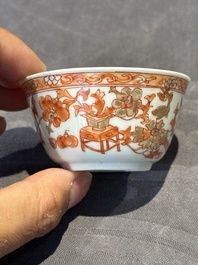 A pair of Chinese polychrome-decorated cups and saucers and an iron-red gilt-decorated cup and saucer, Yongzheng/Qianlong