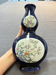 A pair of Chinese famille rose blue-ground wall pocket vases with floral design, Jing Shun Tang 經筍堂 mark, 19th C.
