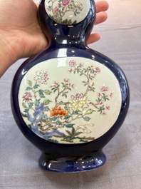 A pair of Chinese famille rose blue-ground wall pocket vases with floral design, Jing Shun Tang 經筍堂 mark, 19th C.