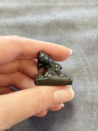 Five Chinese bronze seals and an Indonesian bronze figure group, 18/19th C.