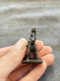 Five Chinese bronze seals and an Indonesian bronze figure group, 18/19th C.