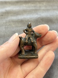 Five Chinese bronze seals and an Indonesian bronze figure group, 18/19th C.