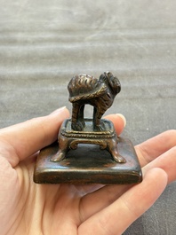 Five Chinese bronze seals and an Indonesian bronze figure group, 18/19th C.