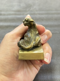 Five Chinese bronze seals and an Indonesian bronze figure group, 18/19th C.