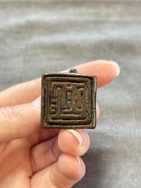 Five Chinese bronze seals and an Indonesian bronze figure group, 18/19th C.