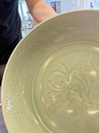 A rare and large Chinese Longquan celadon 'lotus bouquet' dish, Ming, early 15th C.