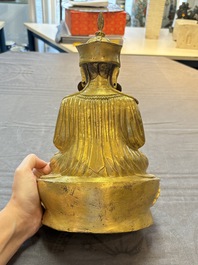 A Tibetan gilt-bronze figure of Padmasambhava holding a cup and a vajra, 17th C. or later