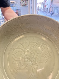 A rare and large Chinese Longquan celadon 'lotus bouquet' dish, Ming, early 15th C.