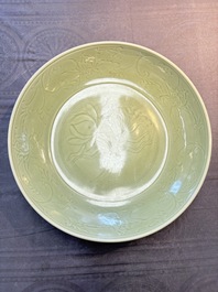 A rare and large Chinese Longquan celadon 'lotus bouquet' dish, Ming, early 15th C.