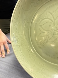 A rare and large Chinese Longquan celadon 'lotus bouquet' dish, Ming, early 15th C.