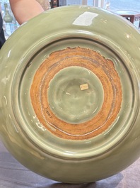 A rare and large Chinese Longquan celadon 'lotus bouquet' dish, Ming, early 15th C.
