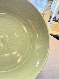 A rare and large Chinese Longquan celadon 'lotus bouquet' dish, Ming, early 15th C.