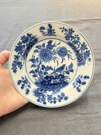 18 Chinese blue and white plates and saucers with floral design, 18th C.