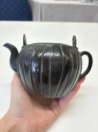 A Chinese bronze teapot and cover with a lion-shaped finial, Yuan