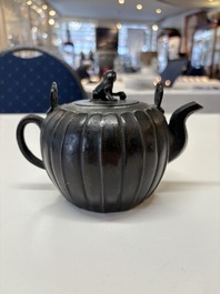 A Chinese bronze teapot and cover with a lion-shaped finial, Yuan