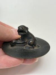 A Chinese bronze teapot and cover with a lion-shaped finial, Yuan