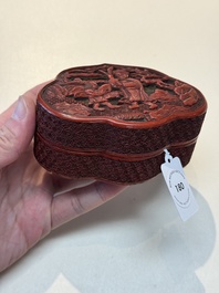 A fine Chinese red cinnabar lacquer ruyi-form 'Ba Man Xian Bao 八蠻獻寶' box and cover, Qianlong