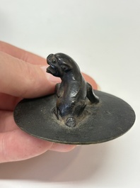 A Chinese bronze teapot and cover with a lion-shaped finial, Yuan