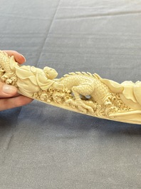 A Chinese ivory carving depicting a Luohan and a dragon, 'Da Ming 大明' mark, 19/20th C.