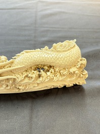 A Chinese ivory carving depicting a Luohan and a dragon, 'Da Ming 大明' mark, 19/20th C.