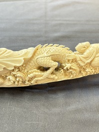 A Chinese ivory carving depicting a Luohan and a dragon, 'Da Ming 大明' mark, 19/20th C.