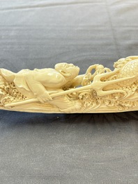 A Chinese ivory carving depicting a Luohan and a dragon, 'Da Ming 大明' mark, 19/20th C.