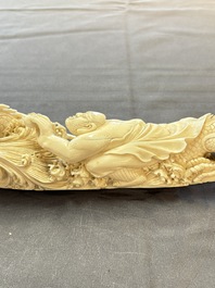 A Chinese ivory carving depicting a Luohan and a dragon, 'Da Ming 大明' mark, 19/20th C.