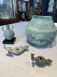 A bronze urn, a bronze canteen with relief design and a pair of bronze oil lamps, Etruscan and Roman civilizations, 9th C. B.C/5th C.