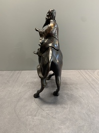 A Japanese gold-splashed bronze incense burner in the shape of an immortal riding a buffalo, ​​Kin San Sō On 金産宗音製造 mark, Meiji, 19th C.