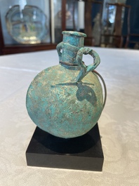 A bronze urn, a bronze canteen with relief design and a pair of bronze oil lamps, Etruscan and Roman civilizations, 9th C. B.C/5th C.